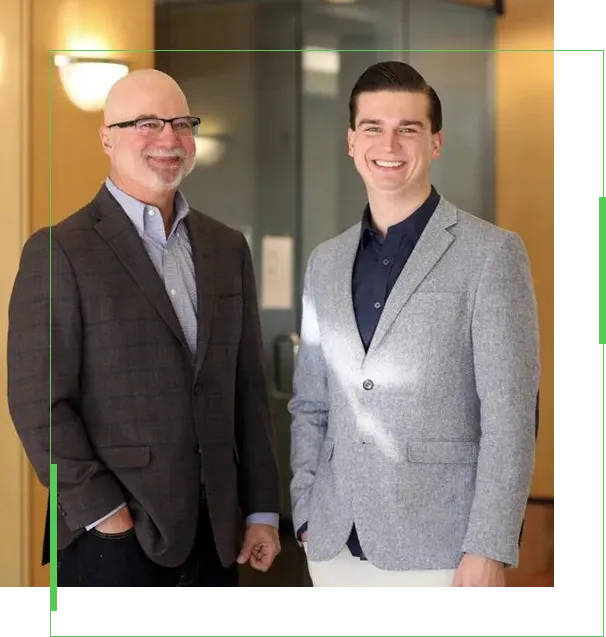 Two men standing next to each other in front of a glass door.