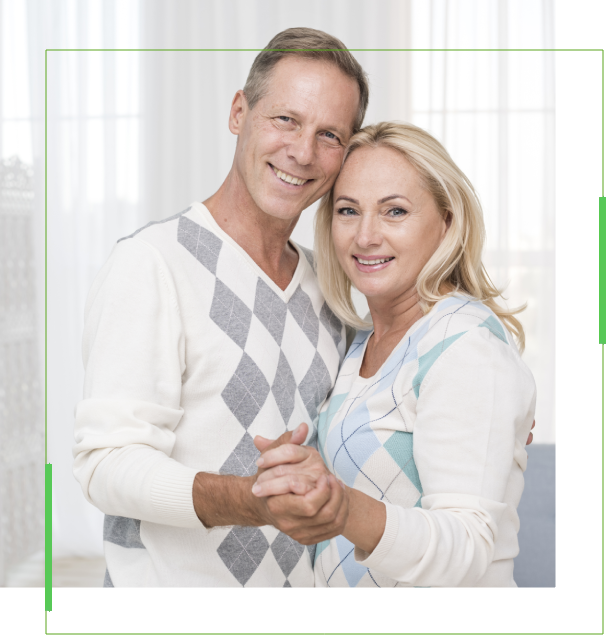 A man and woman holding hands in front of a window.